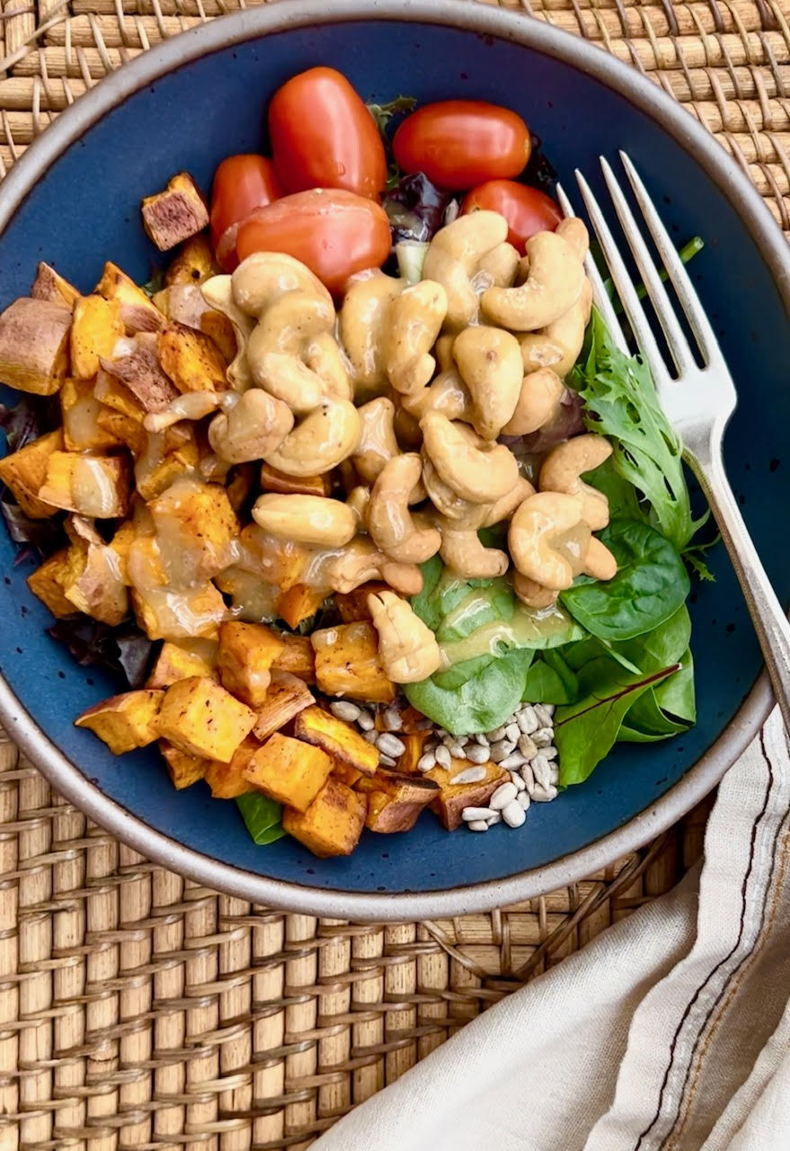 Roasted Sweet Potatoes Topped with Lightly Salted Cashews and Creamy Tahini Dressing